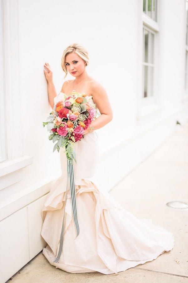 Bride holding brightly coloured bouquet