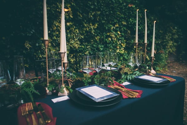 Wedding place setting with dark wedding styling