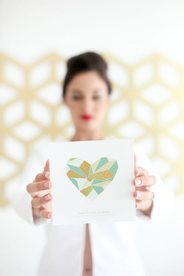 Bride holding geometric wedding invitation