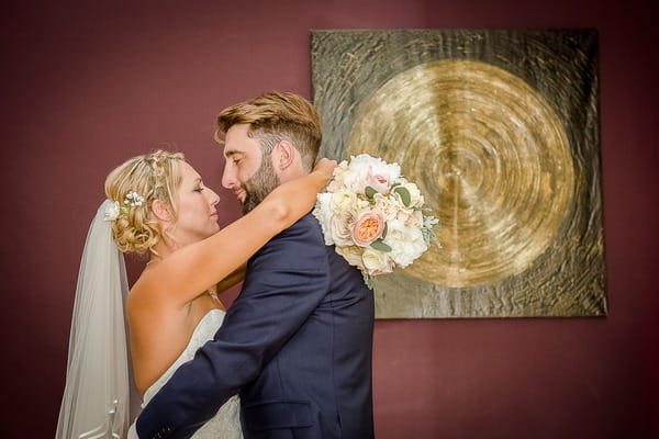 Bride and groom in front of picture