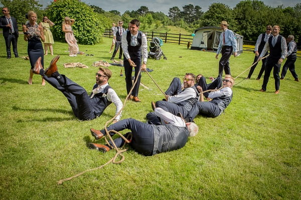 Tug of war team falling over