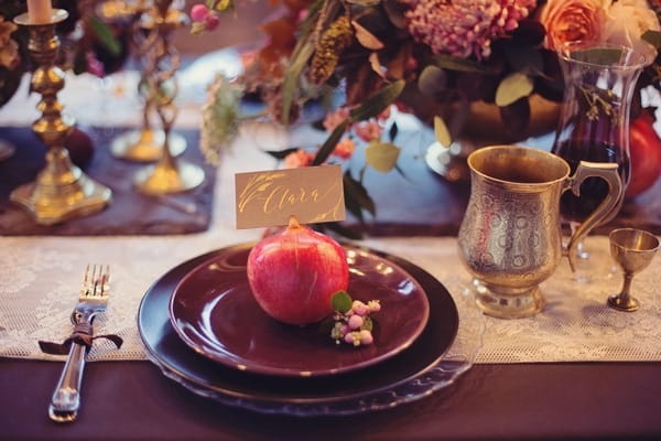 Wedding place setting with dark coloured styling