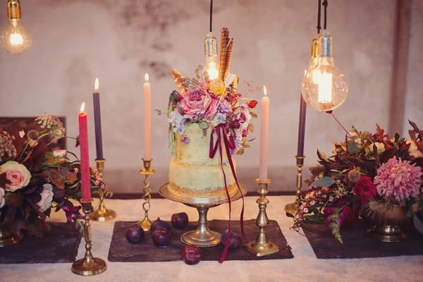 Wedding cake surrounded by candles