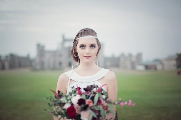 Bride holding bouquet in front of her