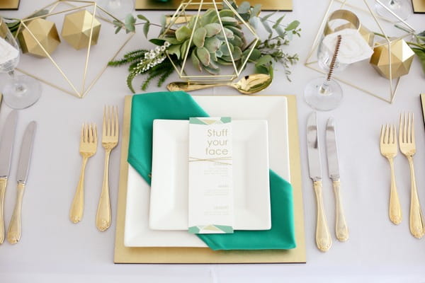Wedding place setting with green and gold styling