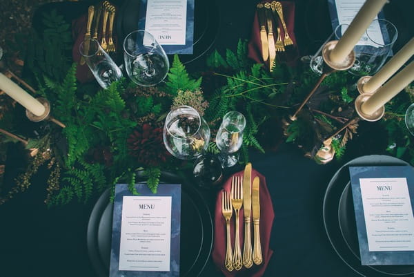 Floral runner and glassware on wedding table