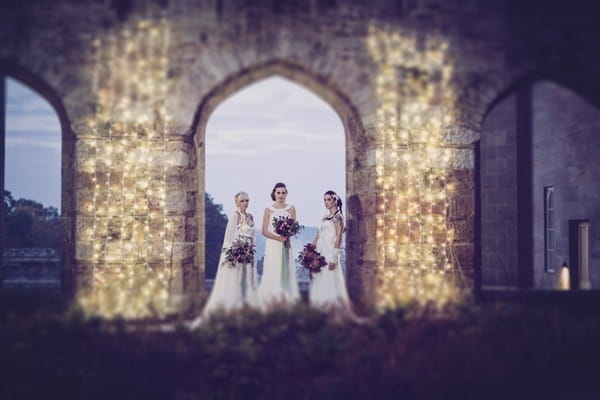 Brides standing in arch