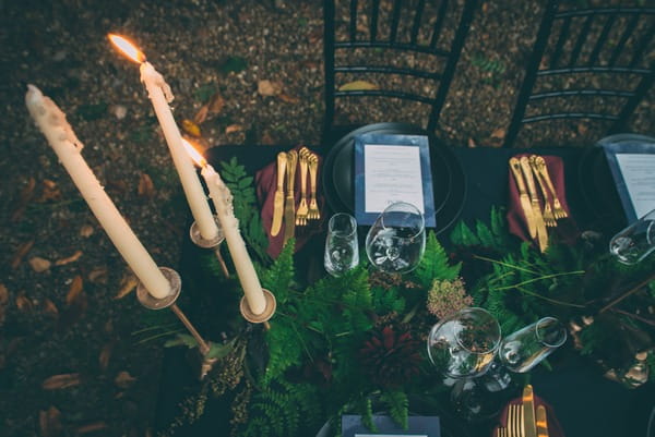 Candlesticks and foliage on wedding table