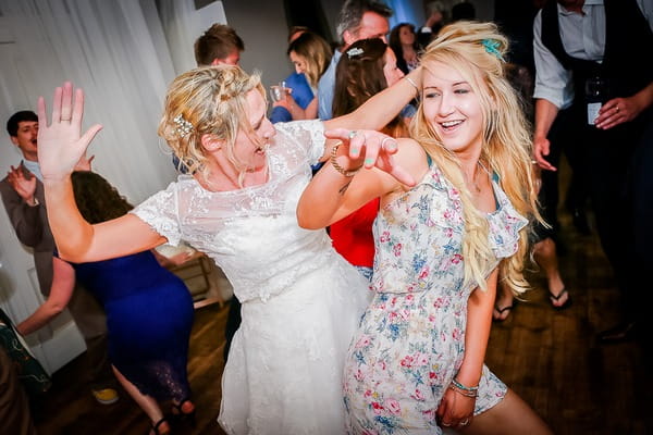 Bride and friend dancing