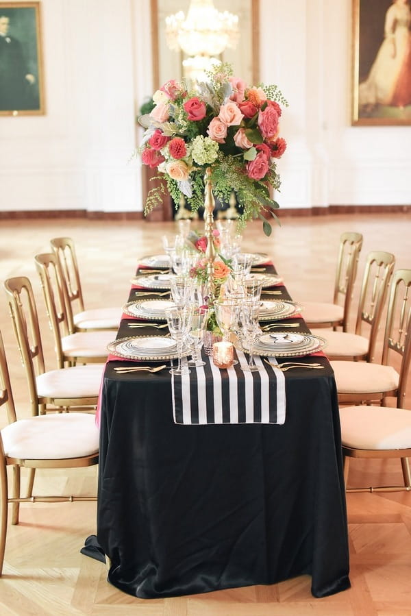 Wedding table with black tablecloth and striped runner