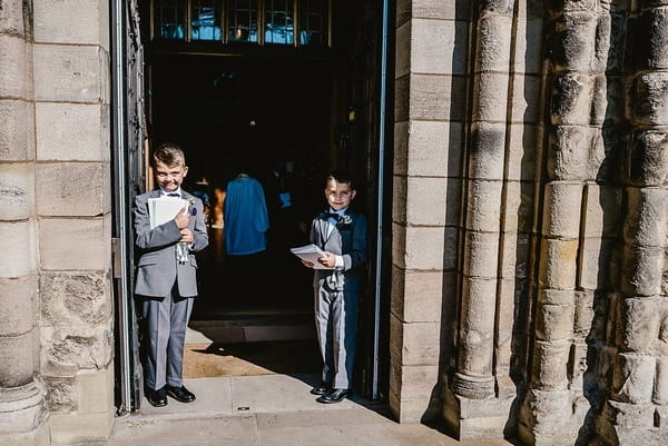 Young ushers at church entrance