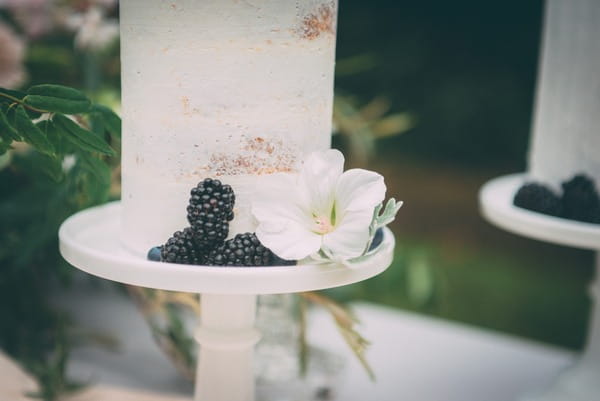 Blackberries and flower on wedding cake