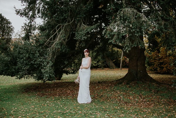 Bride standing under tree