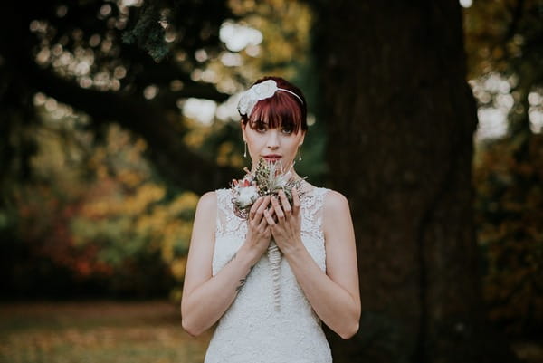 Bride holding bouquet under her chin