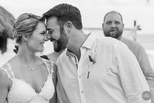 Man pulling funny face behind bride and groom - Picture by That Moment Photo