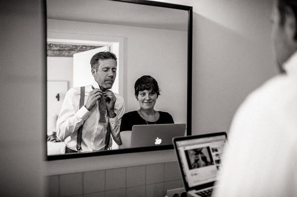 Groom watching video on how to tie a bow tie