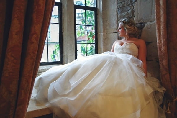 Bride sitting by window