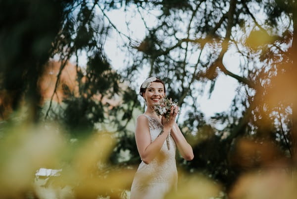 Bride seen through tree branches