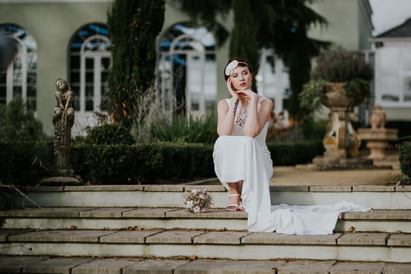 Bride sitting on steps of Deer Park