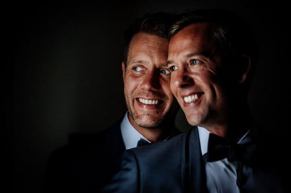 Grooms smiling together