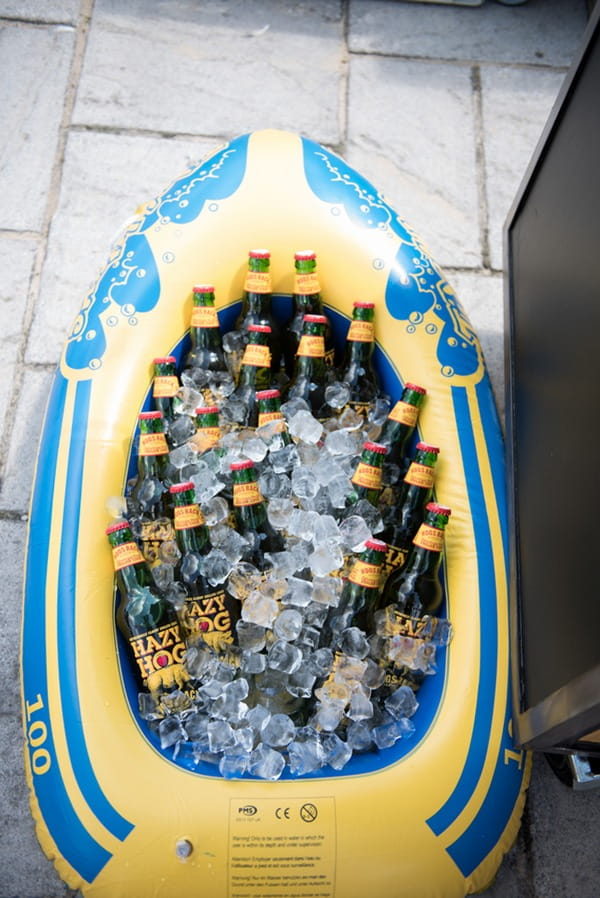 Drinks in dinghy at seaside wedding