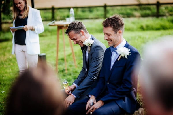 Grooms laughing during wedding ceremony