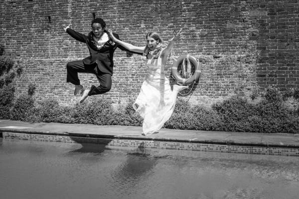 Couple jumping into pool - Picture by Libra Photographic