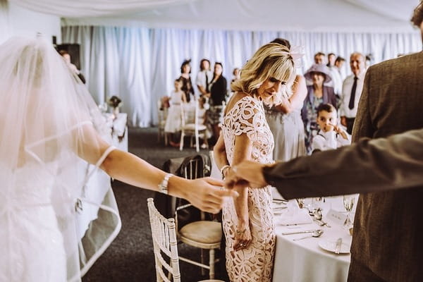 Bride and groom's outstretched hands