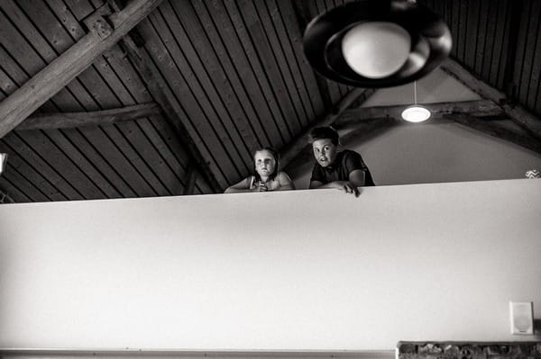 Boys looking over balcony at wedding