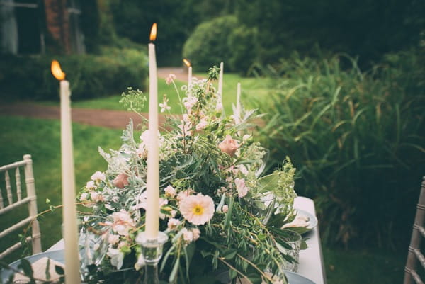 Candles and flowers in middle of wedding table