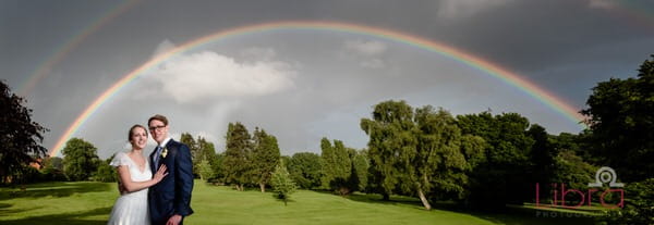 Bride and groom under double rainbow - Picture by Libra Photographic