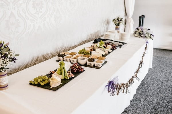 Long table at wedding with cheese and crackers