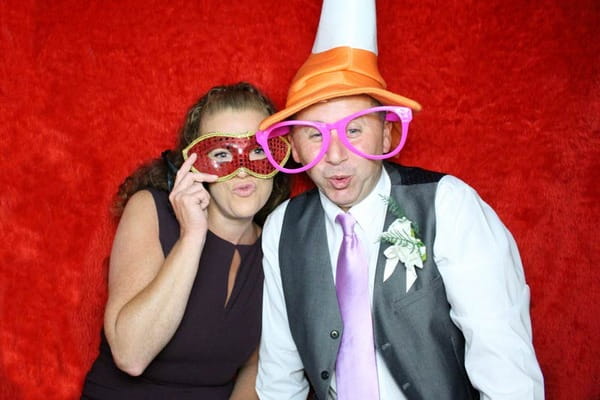 Picture of wedding guests with mark, traffic cone hat and glasses taken in Photosbooths wedding photo booth