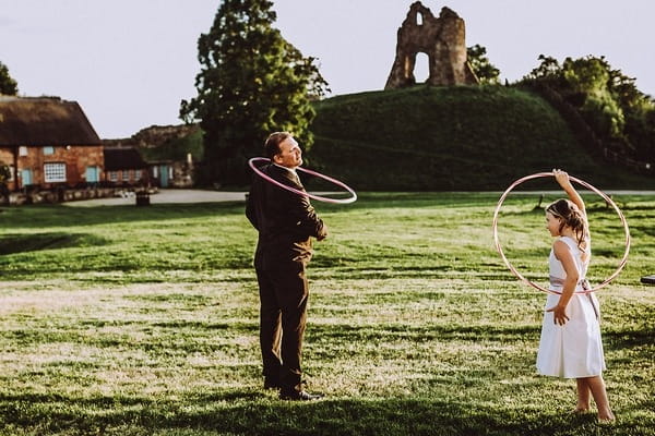 Man and girl playing with hula hoops