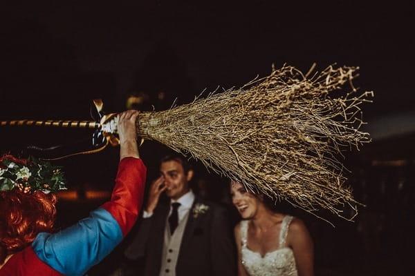 Medieval celebrant holding up broomstick