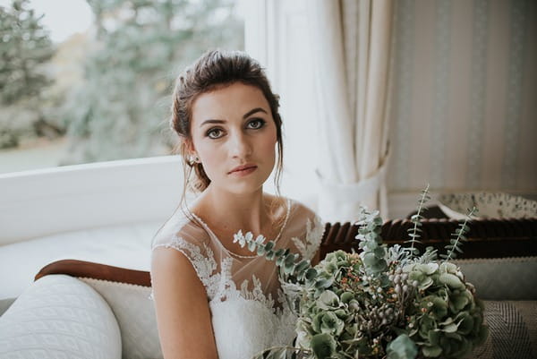 Bride with bouquet looking at camera