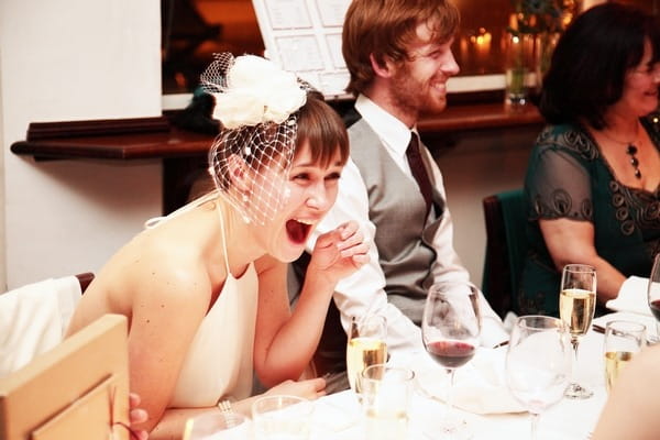 Bride laughing at funny best man speech