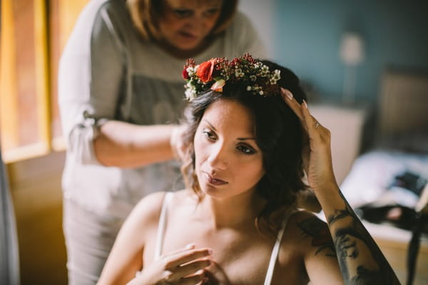 Bride adjusting floral headband