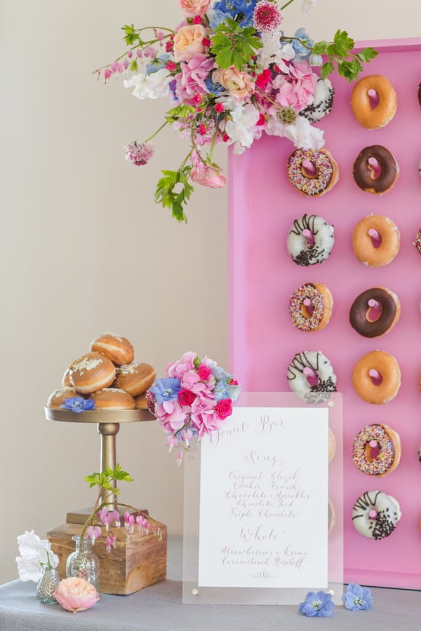 Cake stand of doughnuts and sign