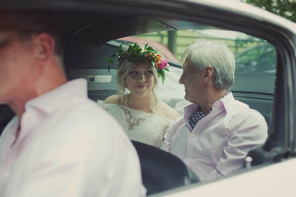 Bride and father sitting in wedding car