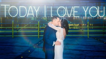 Bride and groom kissing in front of neon sign that says Today I Love You - Picture by Mick Cookson Photography