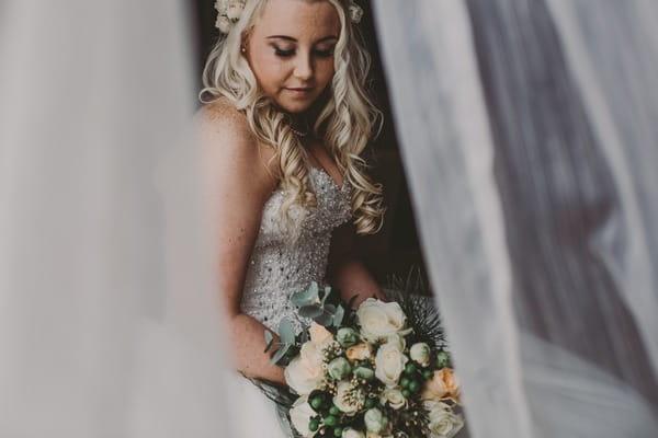 Bride sitting holding bouquet - Picture by Sally Eaves Weddings