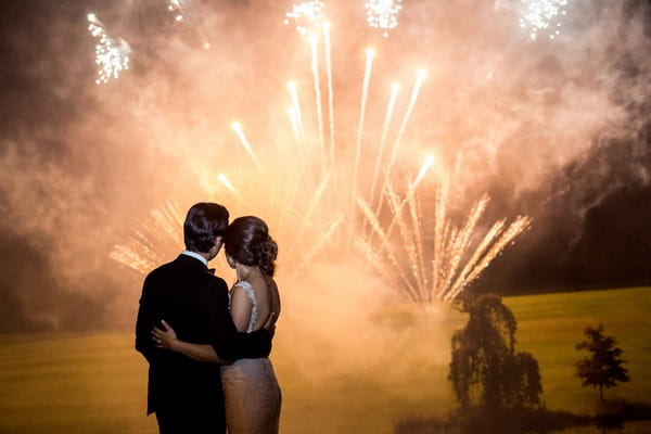 Bride and groom watching firework display - Picture by Focal Point Photography