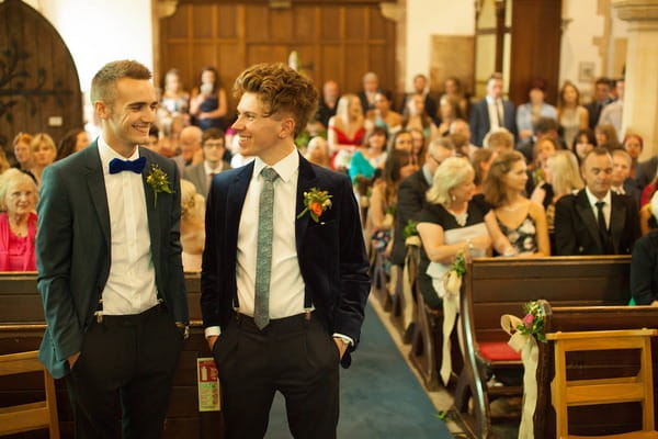 Groom and best man waiting in church for bride