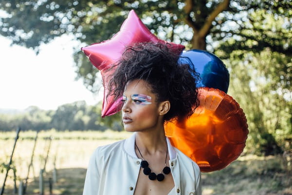 Colourful balloons behind bride's head