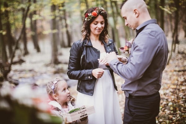 Groom giving ring to bride