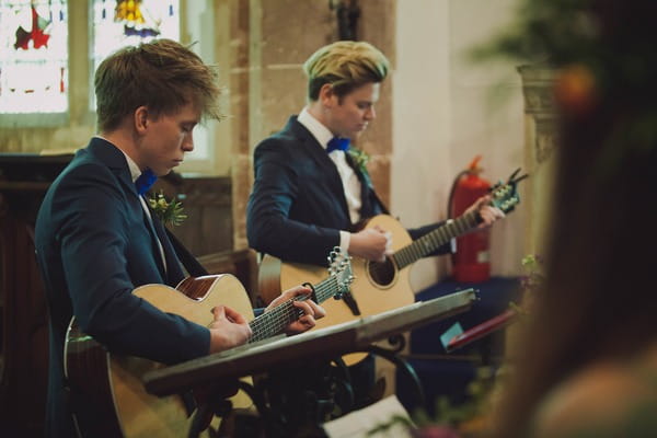 Guitarists playing during church wedding ceremony