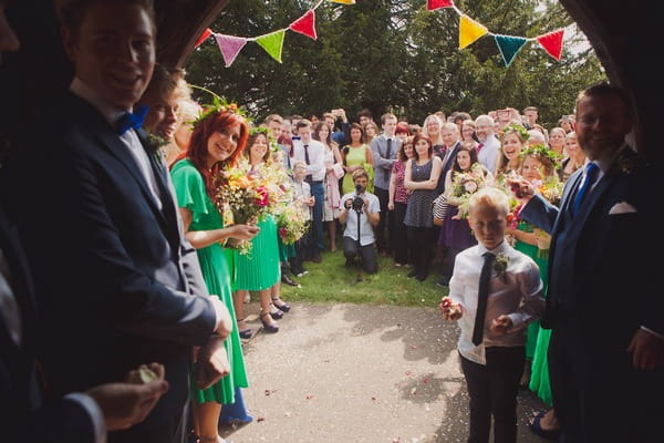 Wedding guests waiting outside church for bride and groom