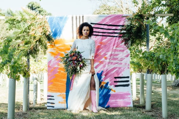 Bride standing against a colourful backdrop