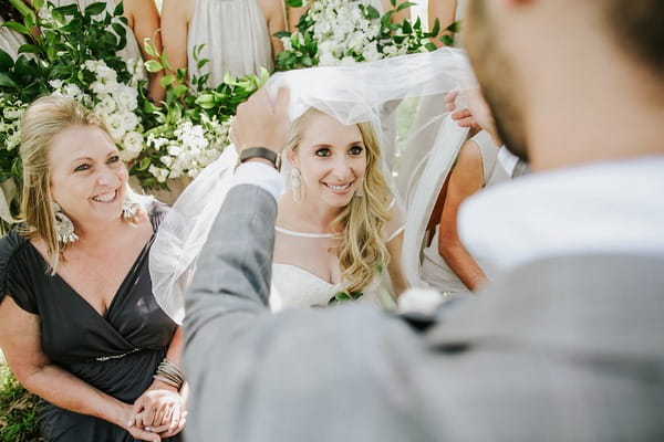 Badekin - groom pulling veil over bride's face